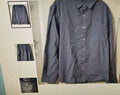 Blue checkered shirt on a bed with smaller images of the shirt on a wall.
