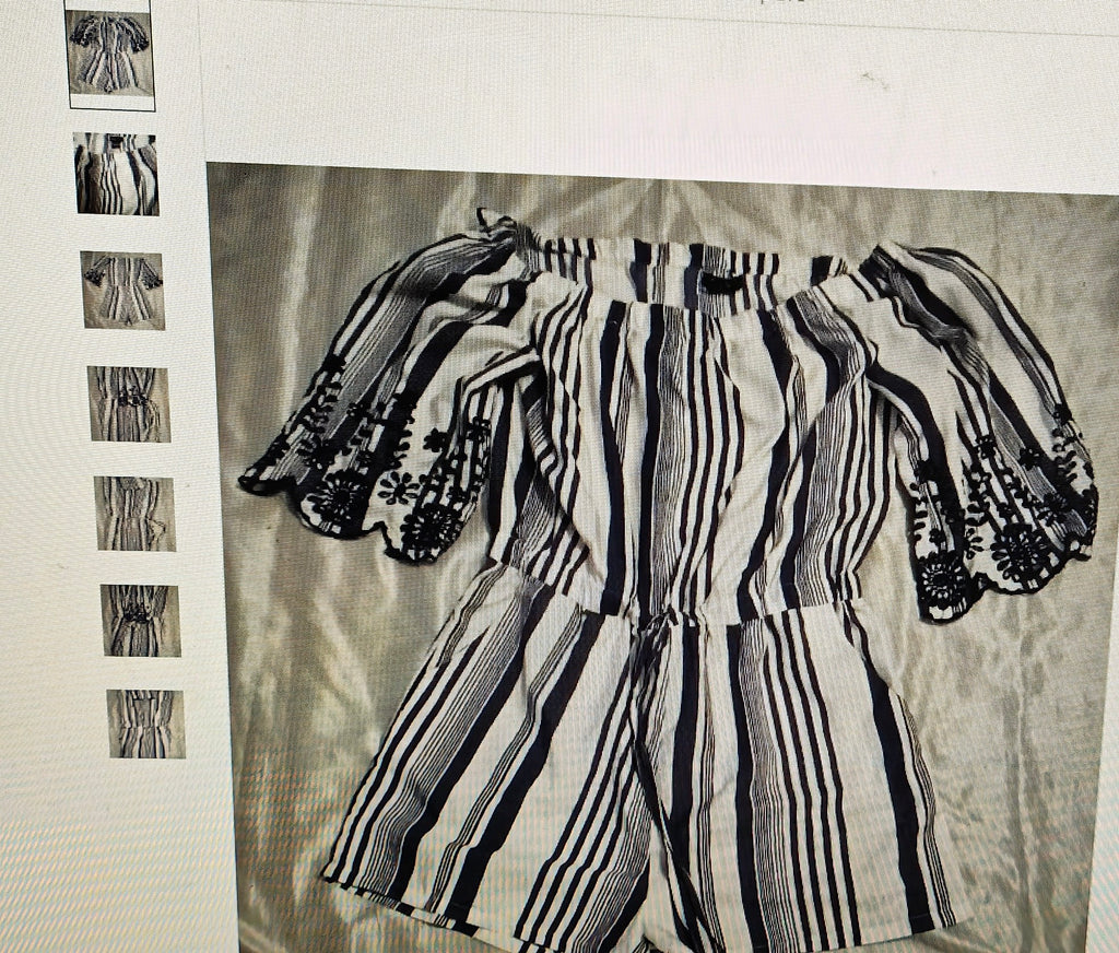Black and white striped outfit on a textured fabric background