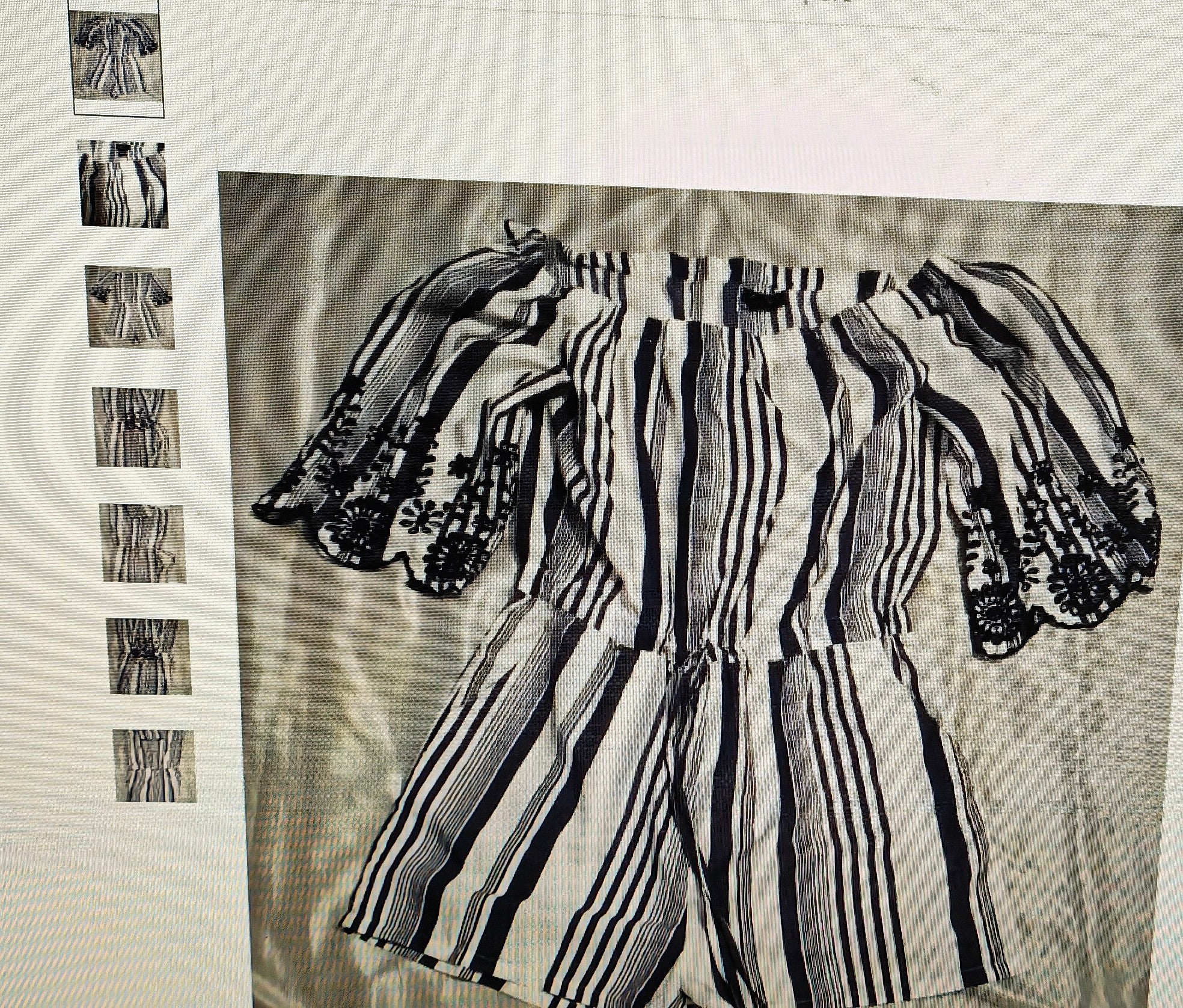 Black and white striped outfit on a textured fabric background