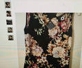 Floral dress with a black background on a textured surface