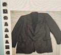 Black pinstripe suit jacket on a light background with a side view.