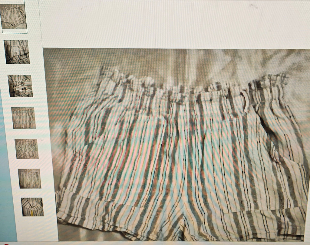 Striped shorts with a pattern of horizontal lines on a textured surface.