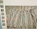 Striped shorts with a pattern of horizontal lines on a textured surface.