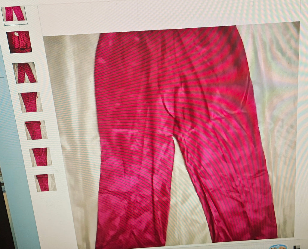 Red pants displayed on a hanger against a white background