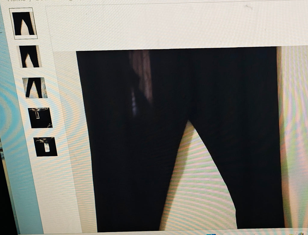 Black pants displayed on a mannequin with size chart on the left.