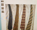Four patterned ties displayed on a textured surface