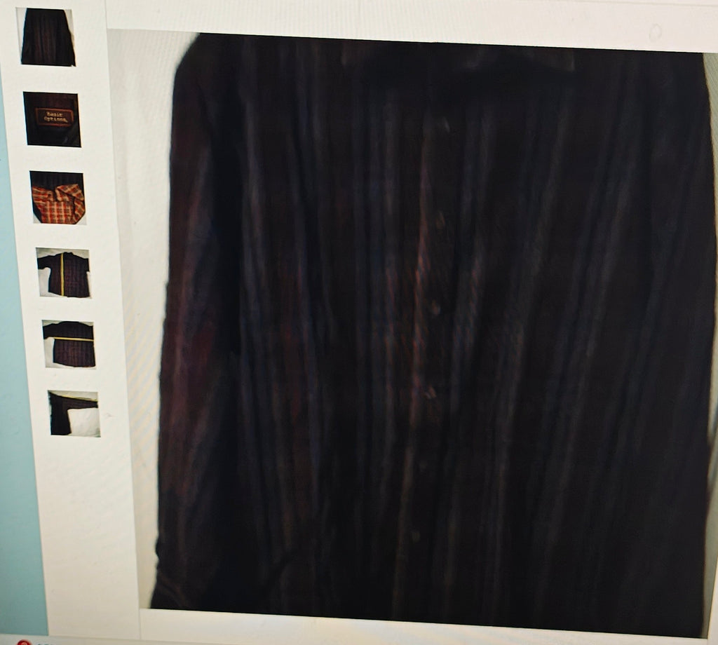 Dark shirt on a hanger with a white background
