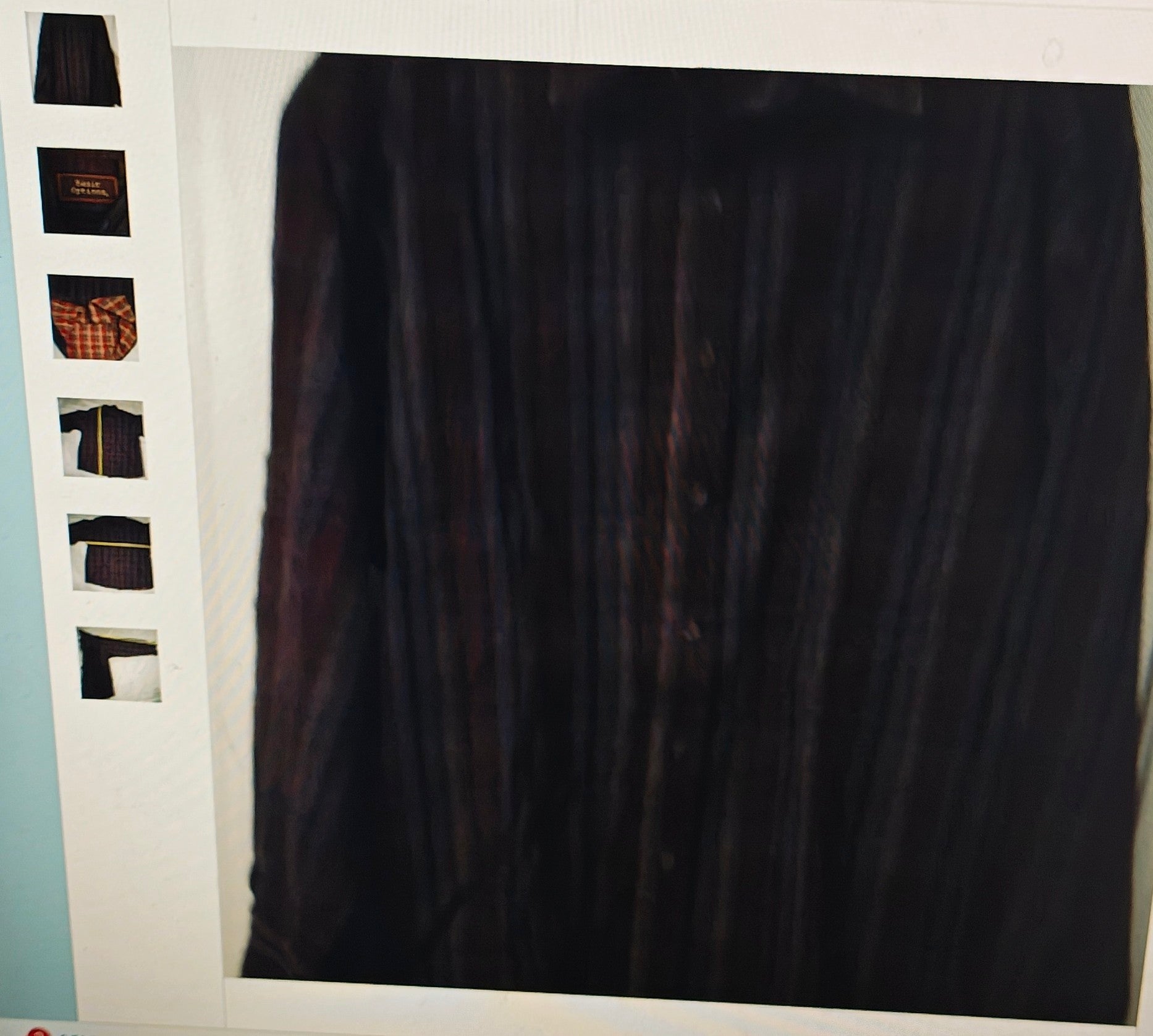 Dark shirt on a hanger with a white background