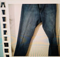 Close-up of dark blue jeans on a white background