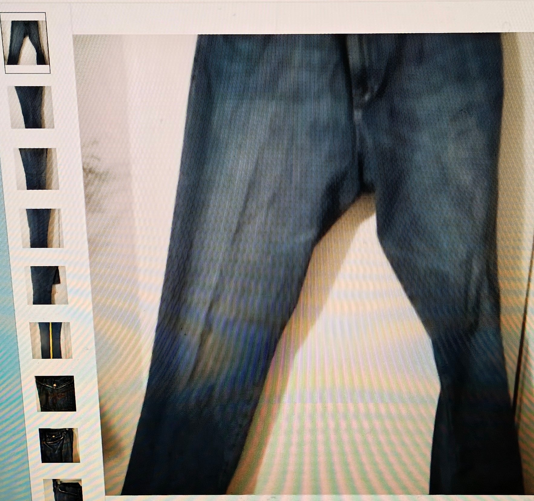Close-up of dark blue jeans on a white background