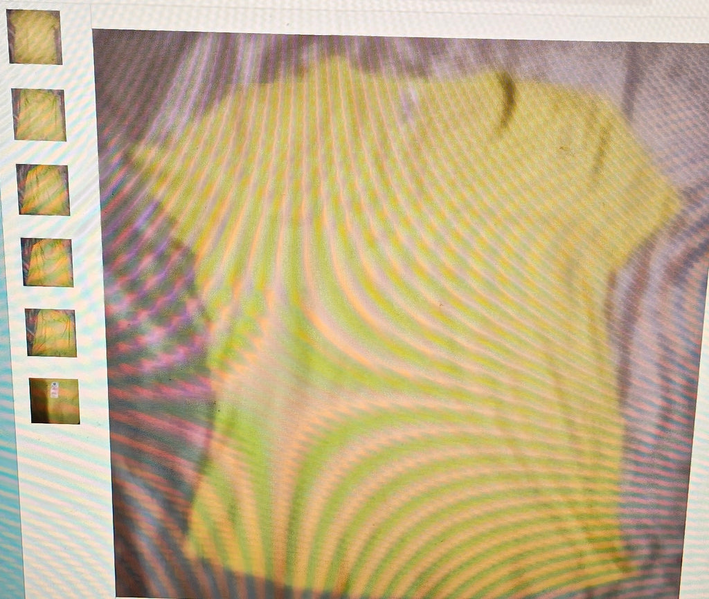 Close-up of a textured yellow fabric with a film strip border.
