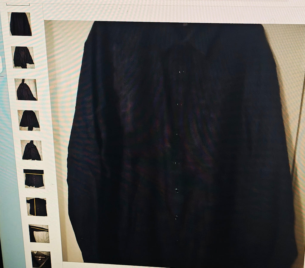 Black shirt on a hanger with a white background