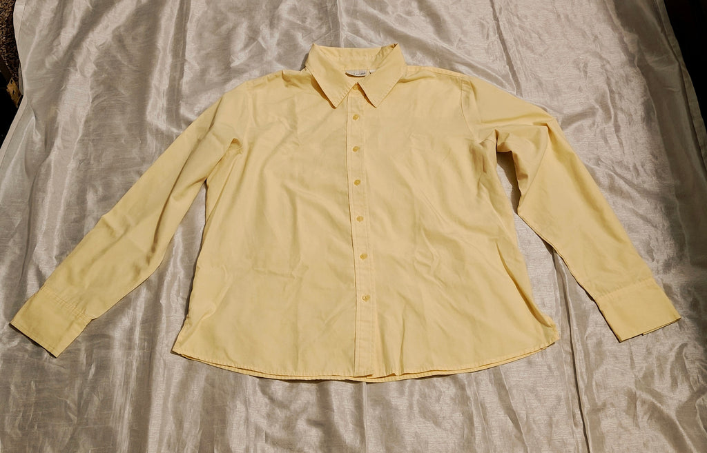 Beige button-up shirt on a textured surface