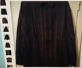 Dark plaid shirt on a hanger against a neutral background