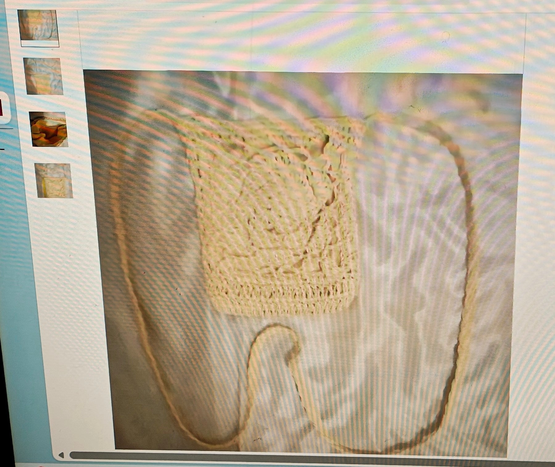 Beige woven bag with a strap on a textured surface