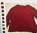 Maroon t-shirt on a white background with a blurred grid pattern