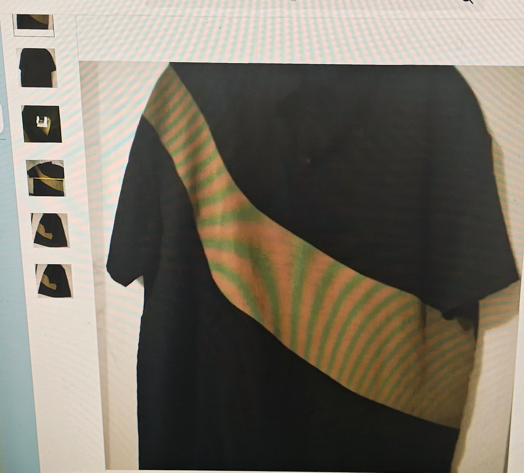 Black t-shirt with green and red striped sleeves on a white background