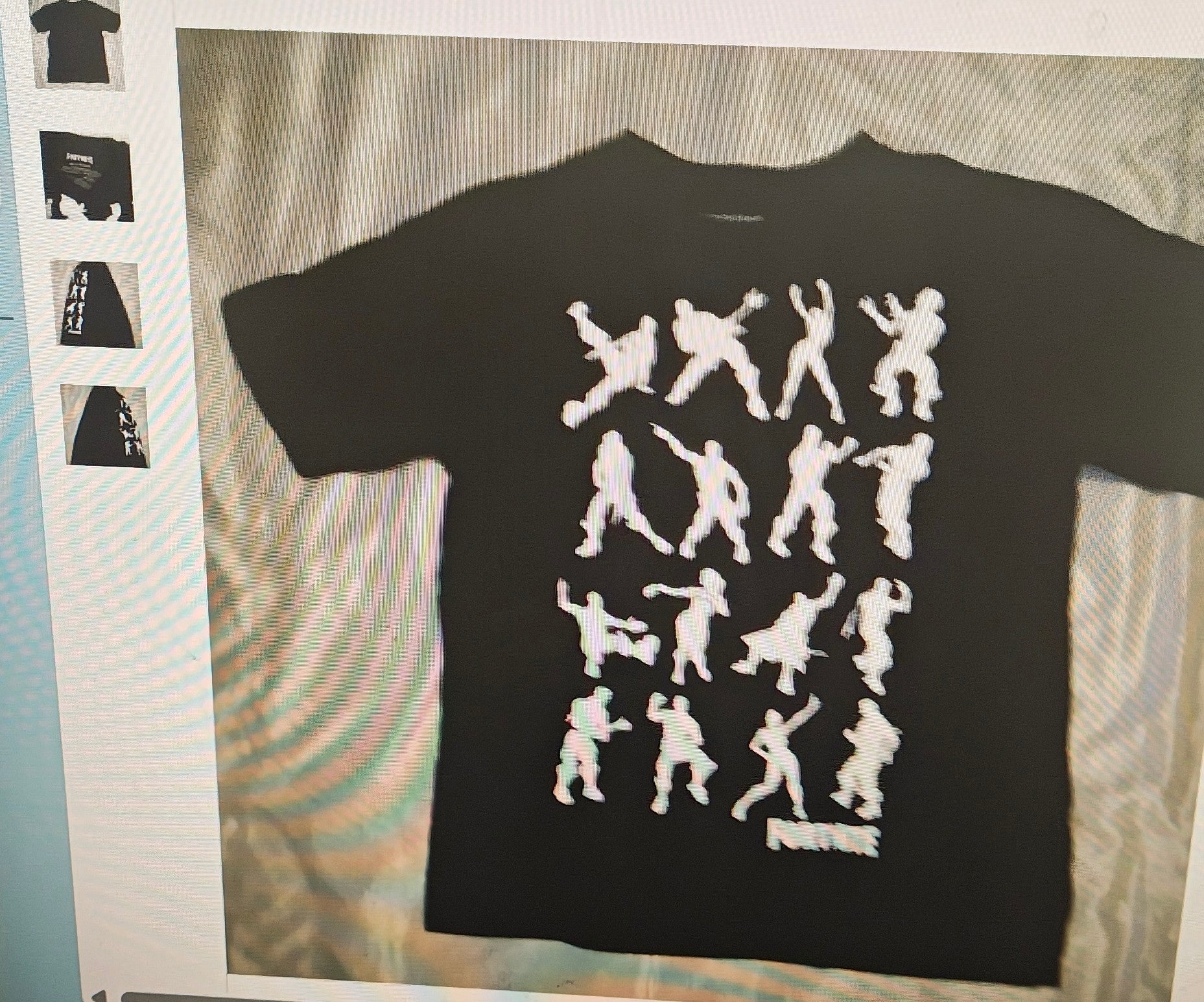 Black t-shirt with white graphic design on a textured surface