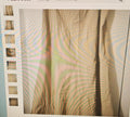 Close-up of a textured fabric with wavy patterns on a light background