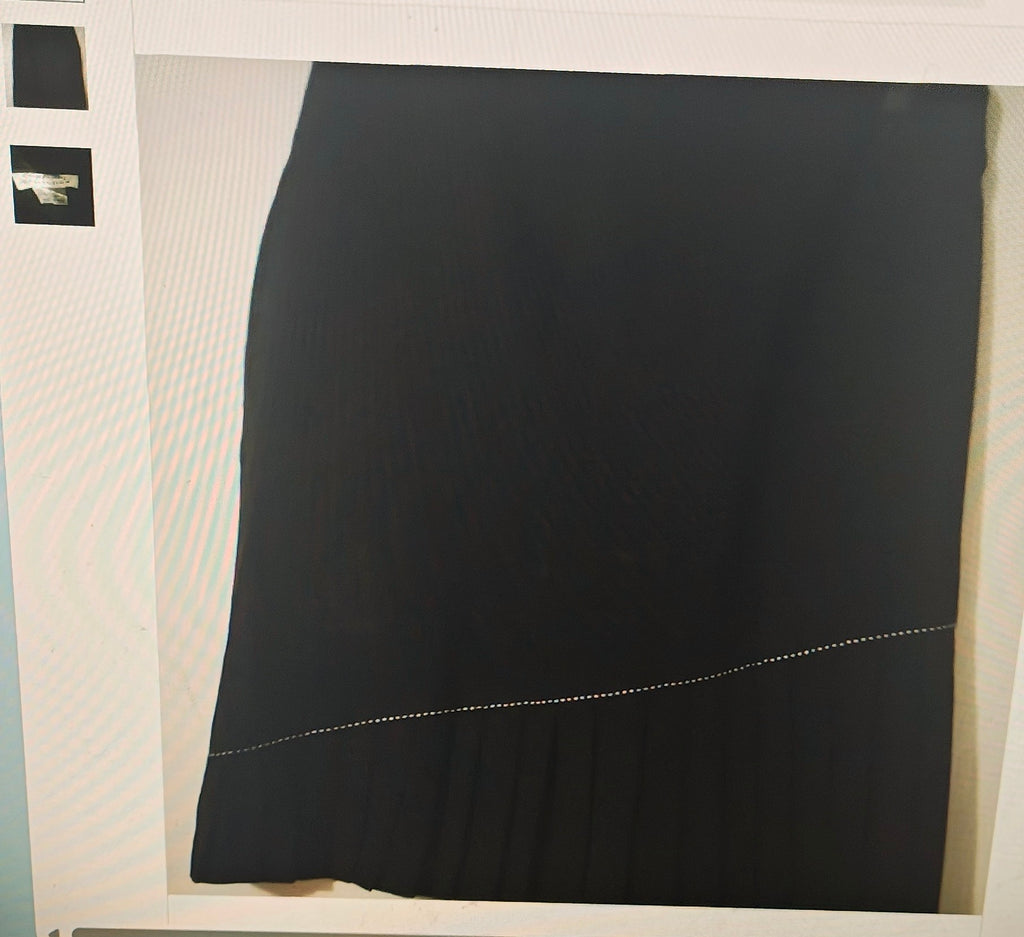 Black skirt on a mannequin against a white background