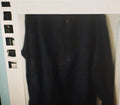 Black shirt hanging on a rack with a white background