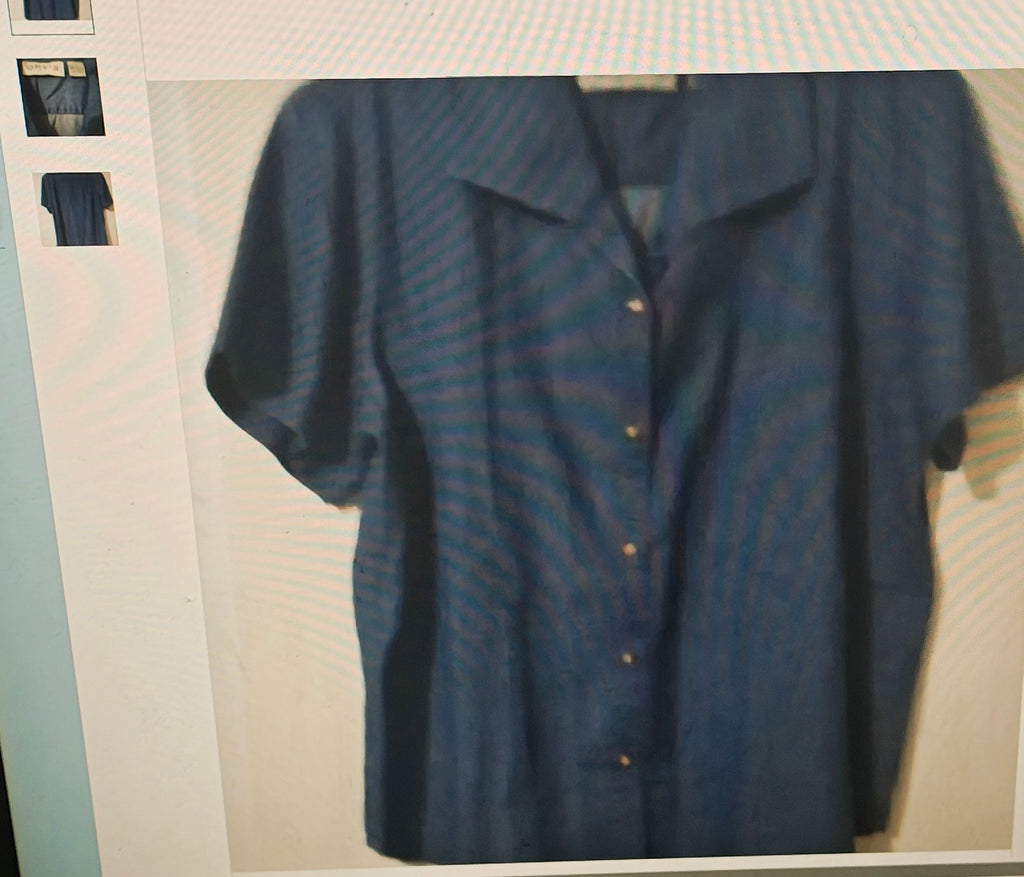 Blue shirt on a hanger against a neutral background