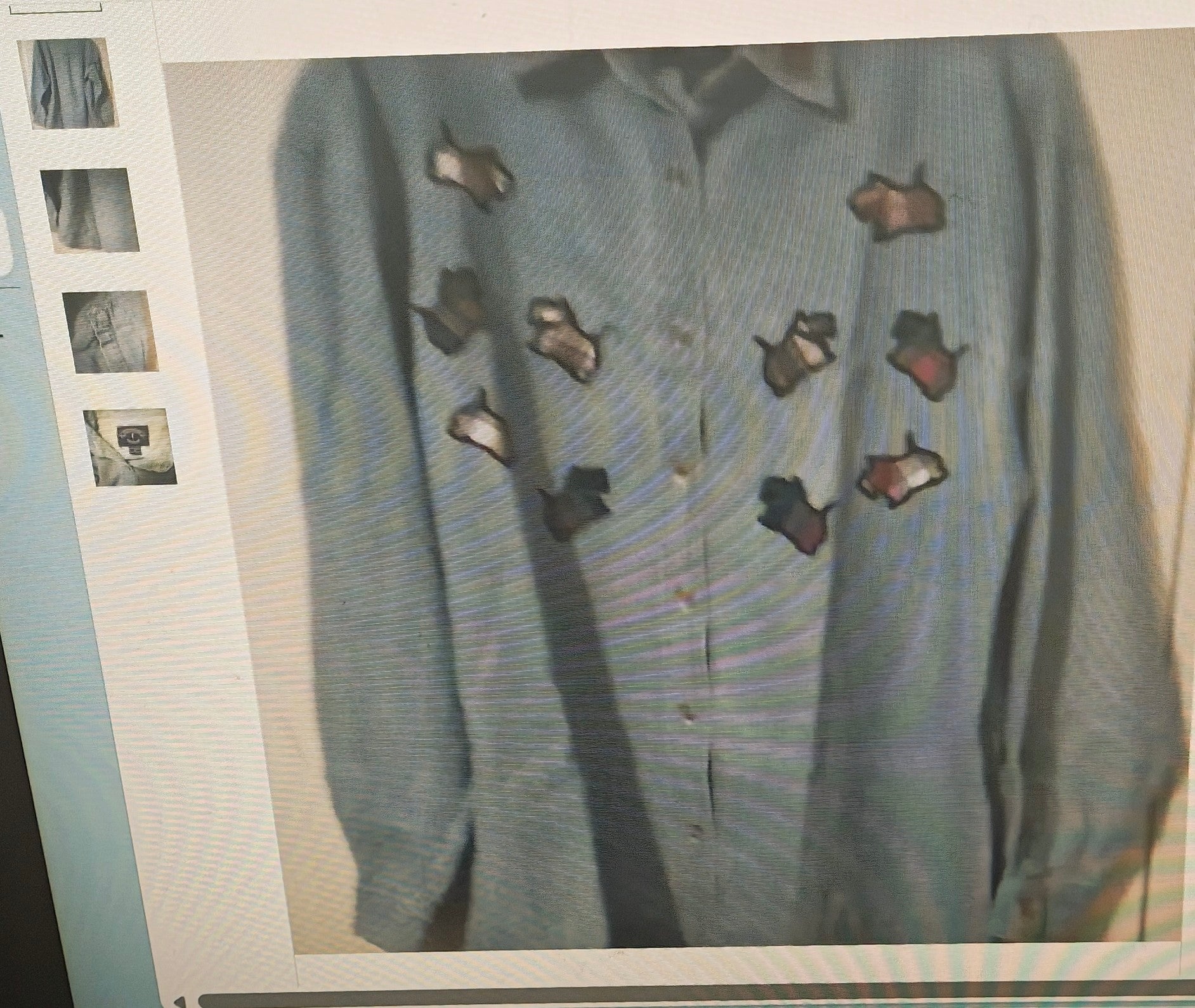 Light blue sweater with cut-out patterns on a textured surface