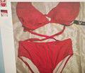 Red bikini set on a light-colored surface