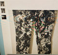 Camouflage-patterned pants on a white background with small images above