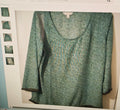 Green patterned top on a light gray background