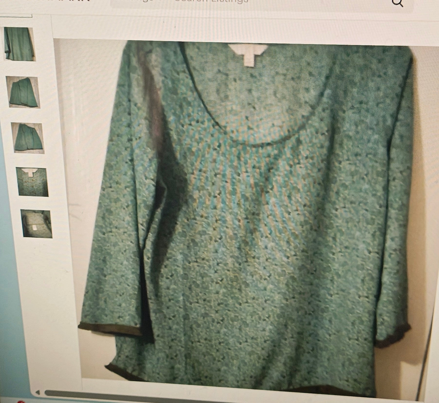 Green patterned top on a light gray background