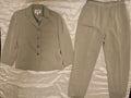 Beige suit jacket and pants on a textured surface