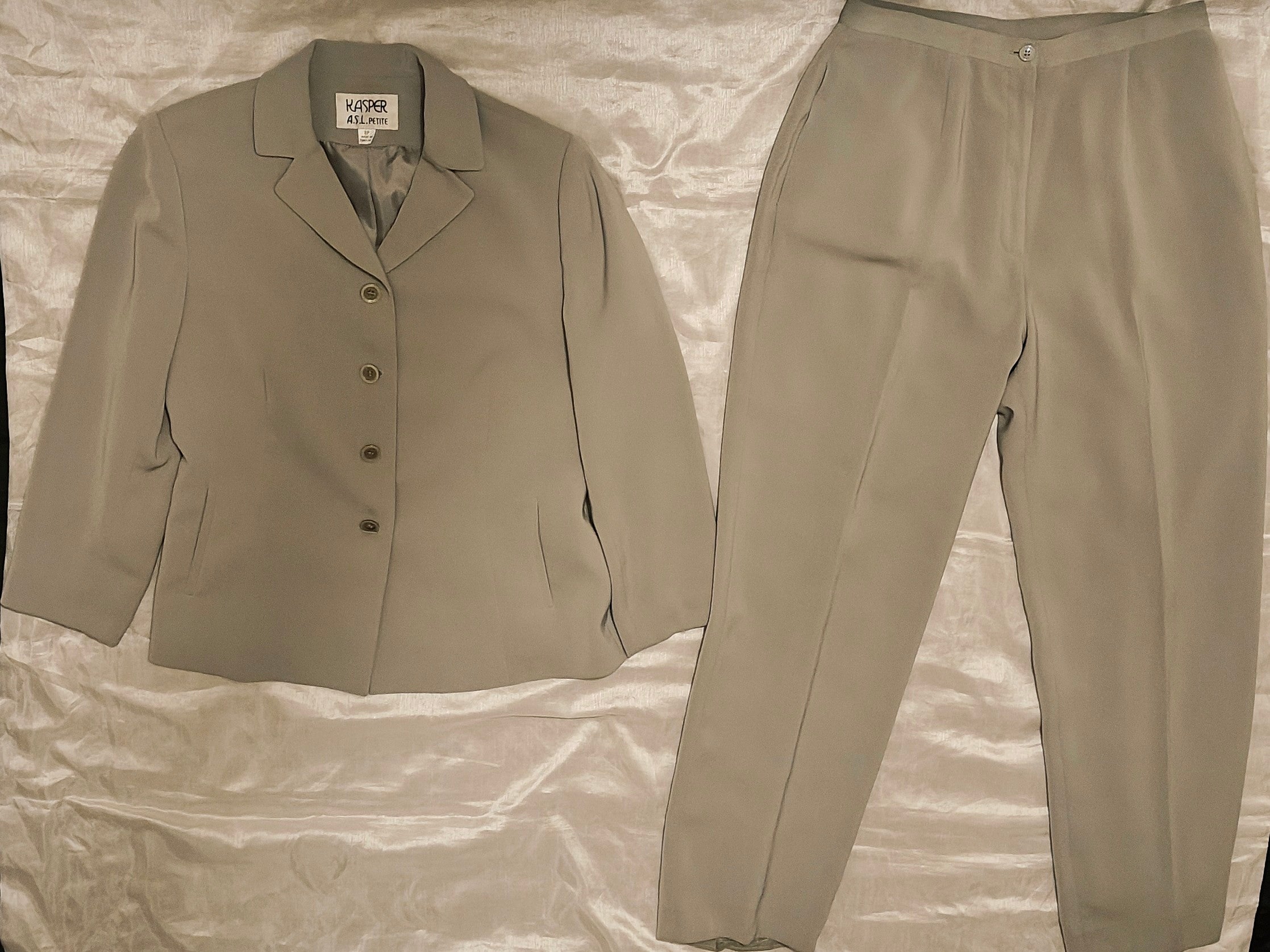 Beige suit jacket and pants on a textured surface
