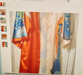 Colorful fabric draped over a chair with a neutral background