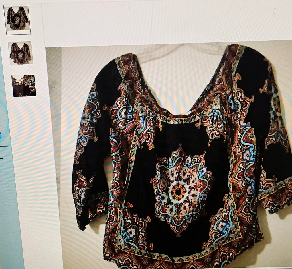 Black top with colorful pattern on a white background