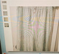 Computer screen displaying a blurred image of a curtain with a building in the background