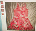 Red and white patterned dress on a textured surface