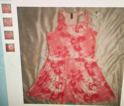 Red and white patterned dress on a textured surface