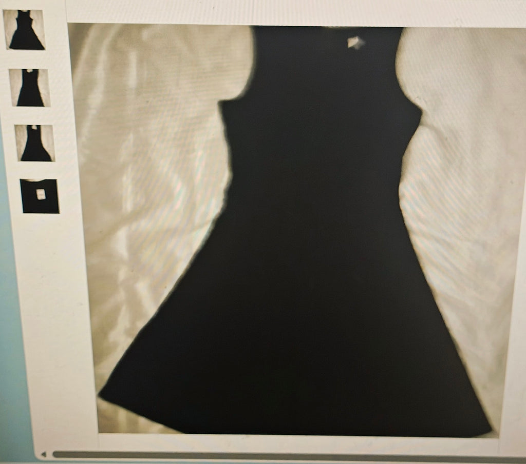 Black dress on a mannequin with a vintage film strip border