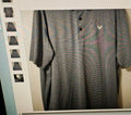 Striped polo shirt on a hanger with a blurred background
