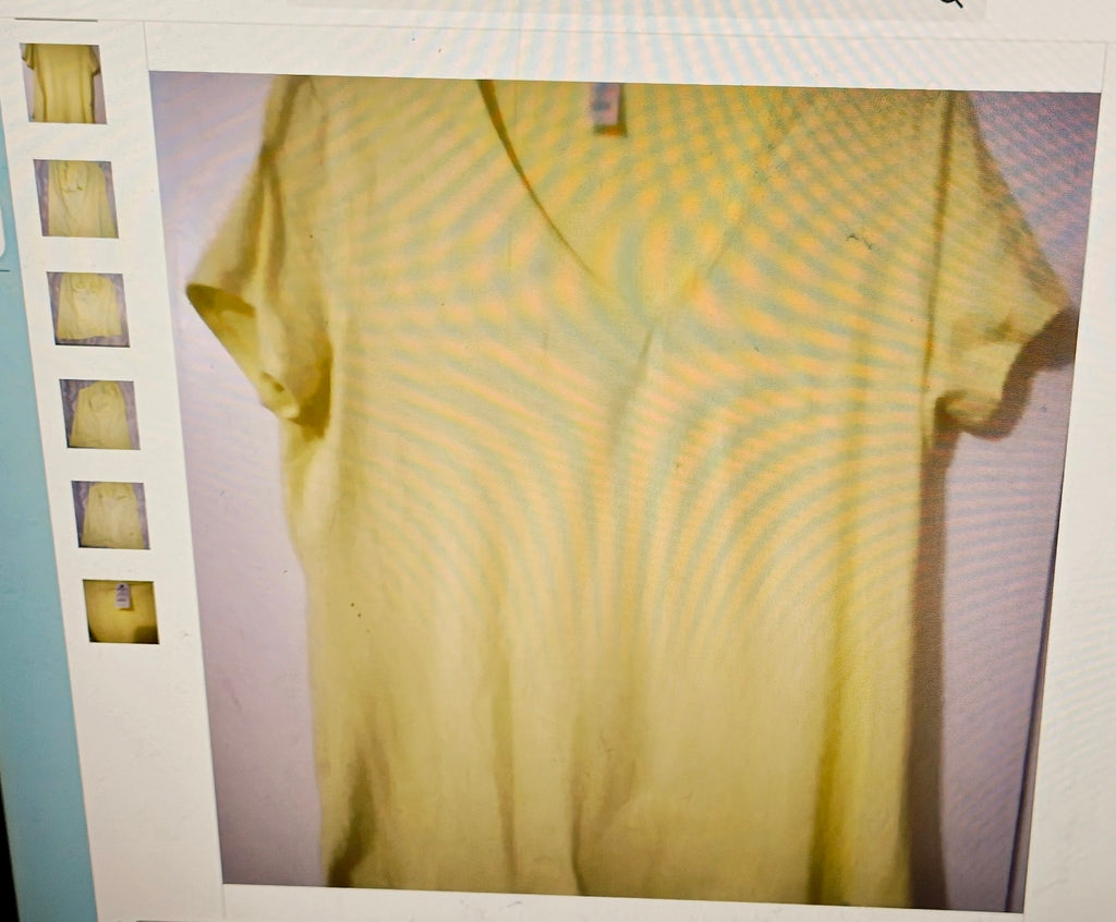 Yellow t-shirt on a light purple background with a white border