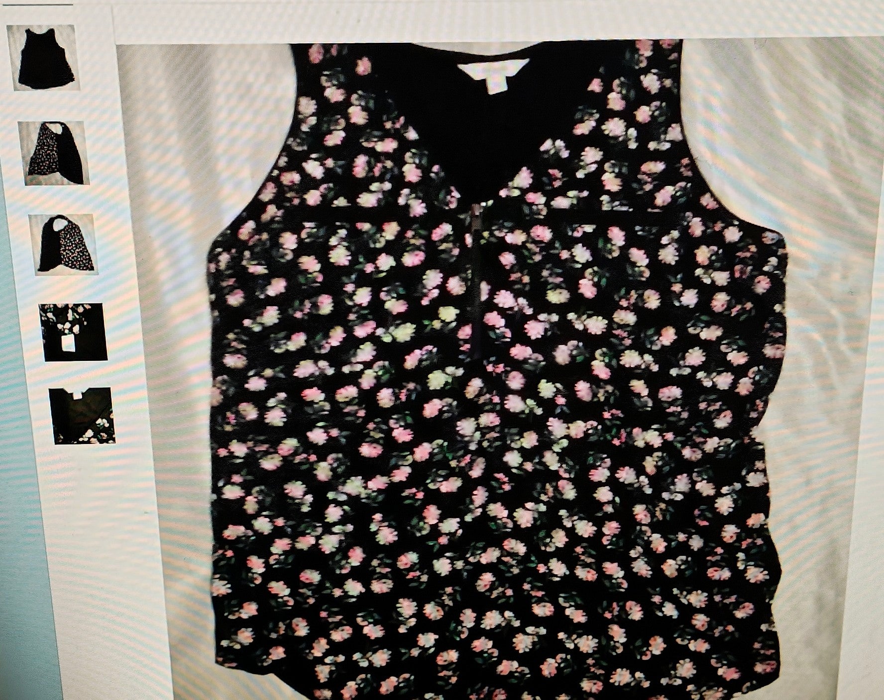 Floral-patterned sleeveless top on a light gray background