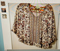 Floral patterned blouse on a light background
