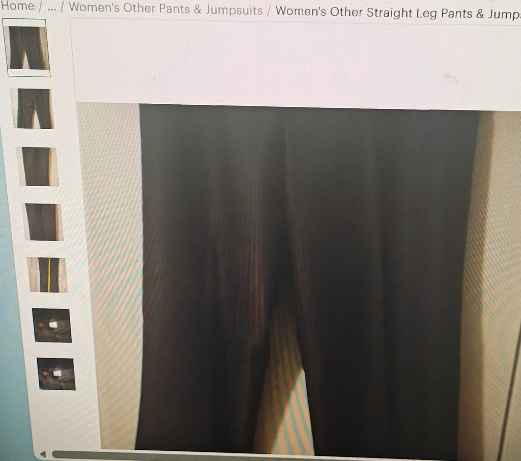 Dark pants displayed on a mannequin with a light gray background