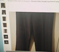 Dark pants displayed on a mannequin with a light gray background