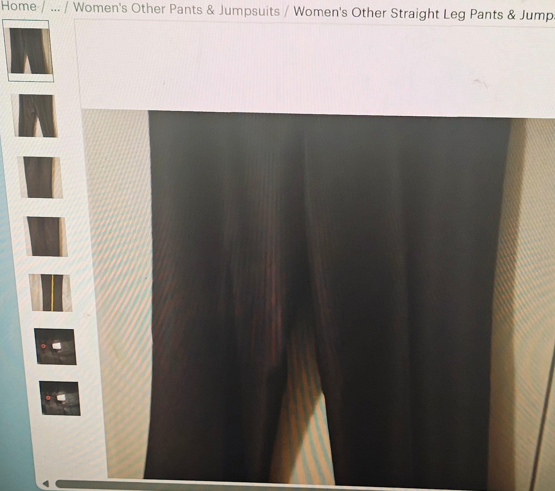 Dark pants displayed on a mannequin with a light gray background