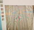 Plaid fabric with a pattern of brown, green, and pink on a white background.