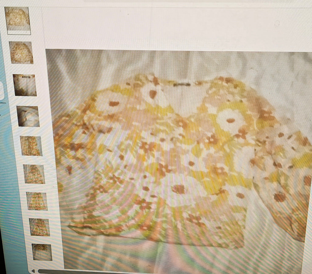 Close-up of a textured surface with floral patterns and a film strip border.