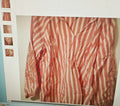 Striped shirt with red and white pattern on a light background