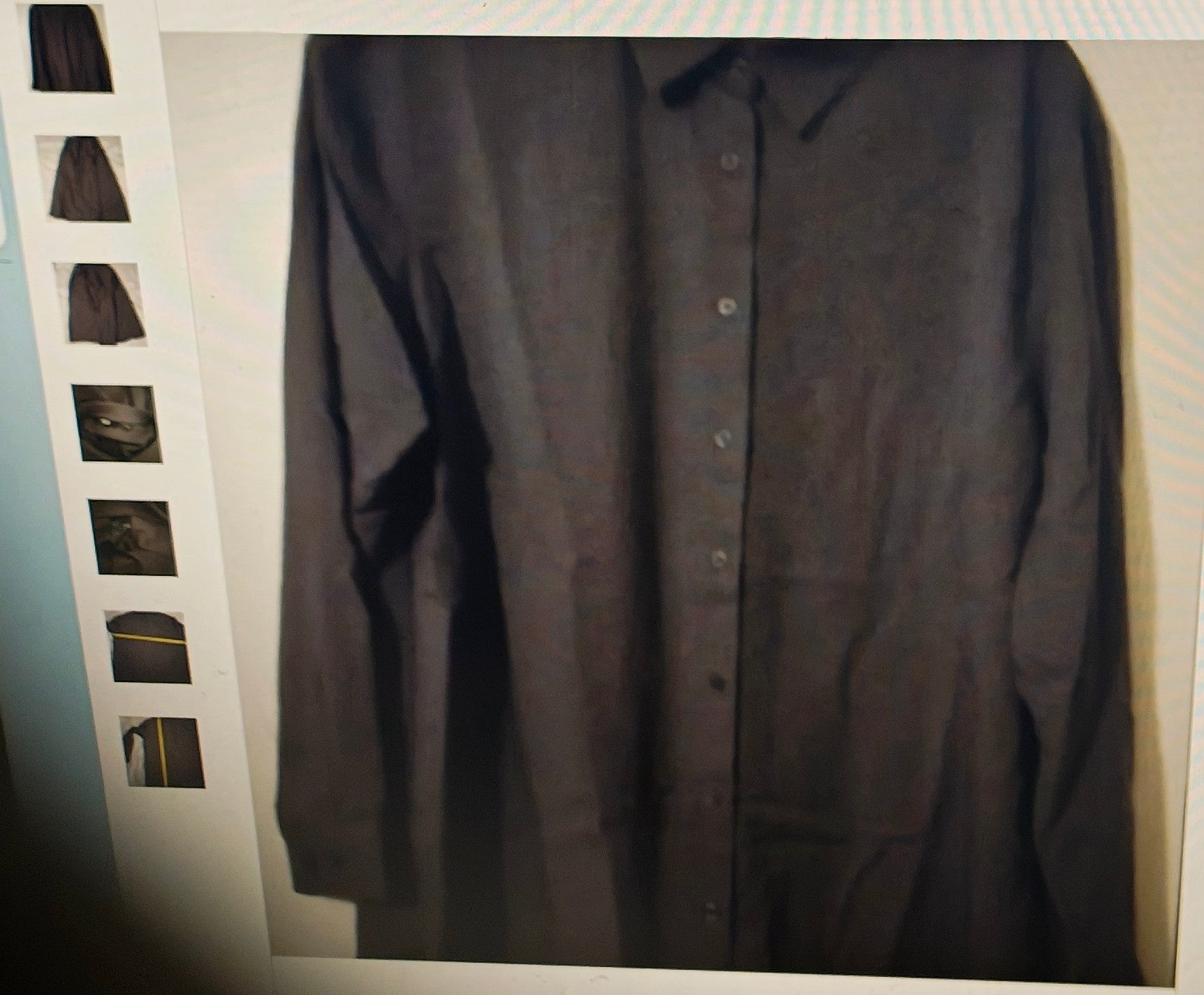 Dark gray button-up shirt on a hanger with a white background